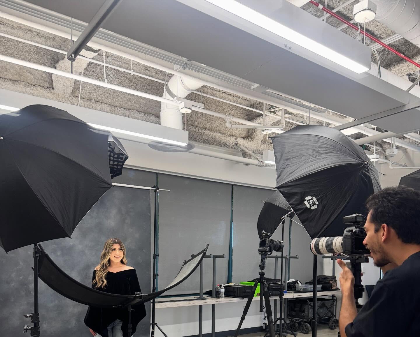 Behind-the-scenes photo shoot in Oscar's Photography studio with professional lighting equipment