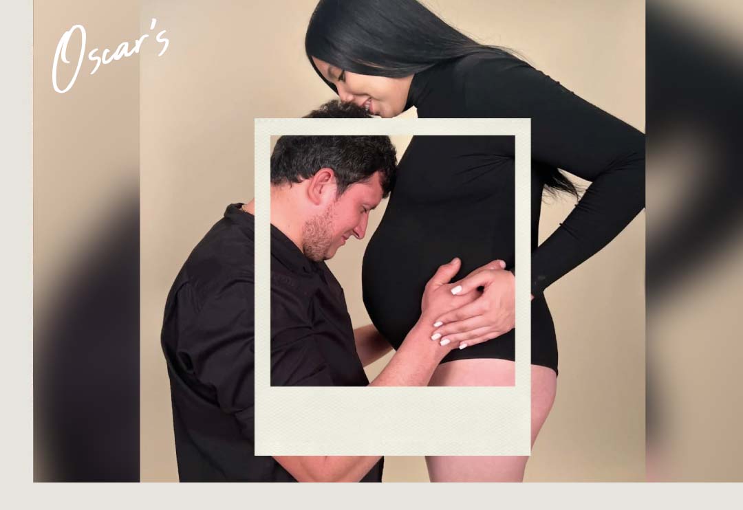 husband kissing pregnant belly, styled as a framed Polaroid image with "Oscar's" branding, warm tan backdrop