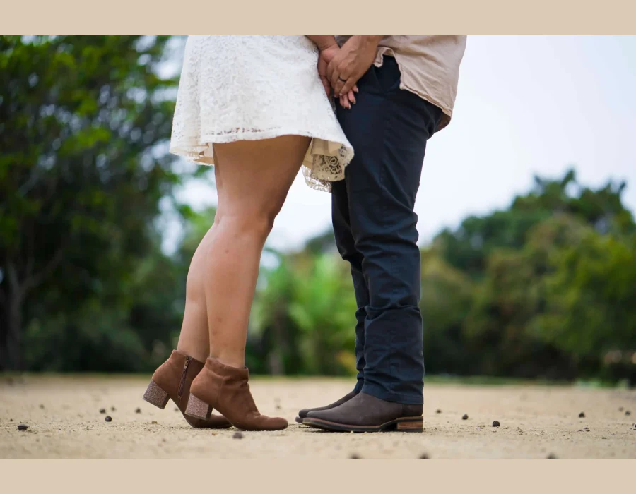 Wedding couple's feet detail shot — close-up of the bride and groom's shoes while standing close together outdoors