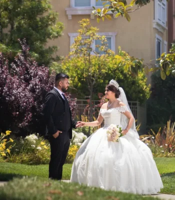Wedding couple first look in garden — couple holding hands outdoors in a landscaped garden