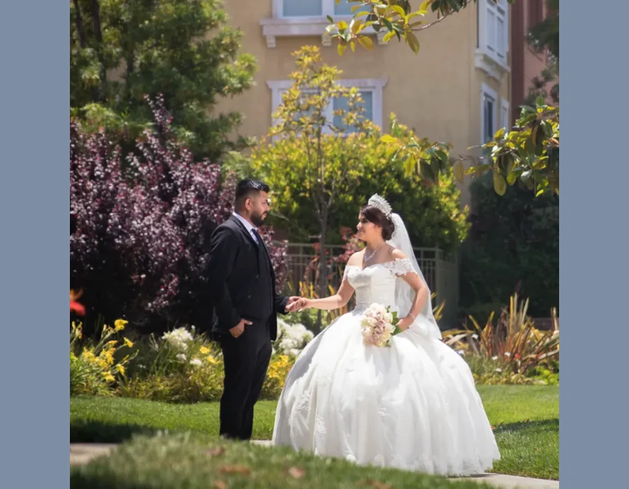 Wedding couple first look in garden — couple holding hands outdoors in a landscaped garden