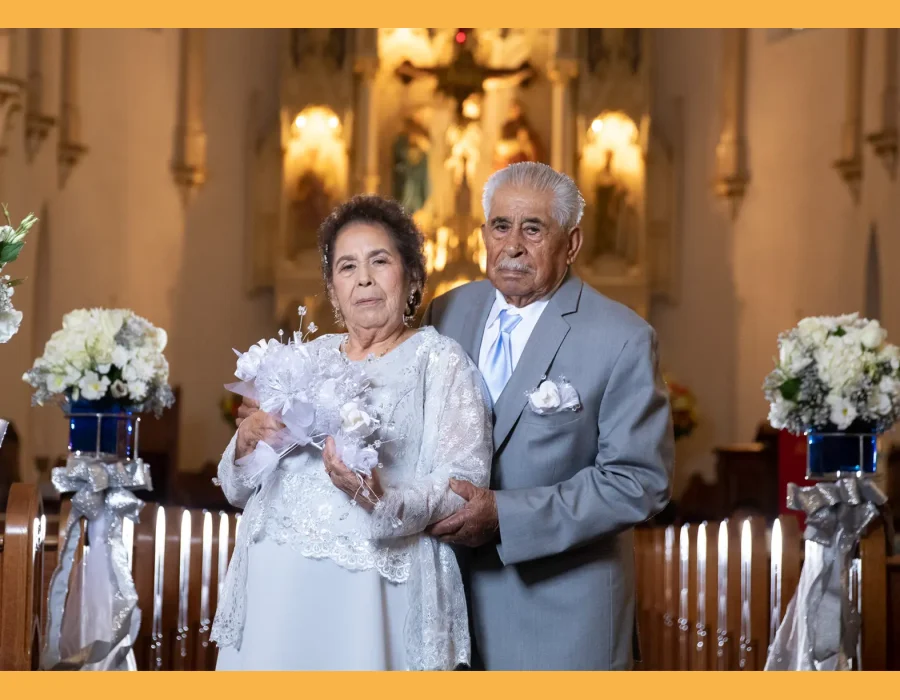 Wedding couple portrait inside church — older couple posing near the altar, bride holding a bouquet